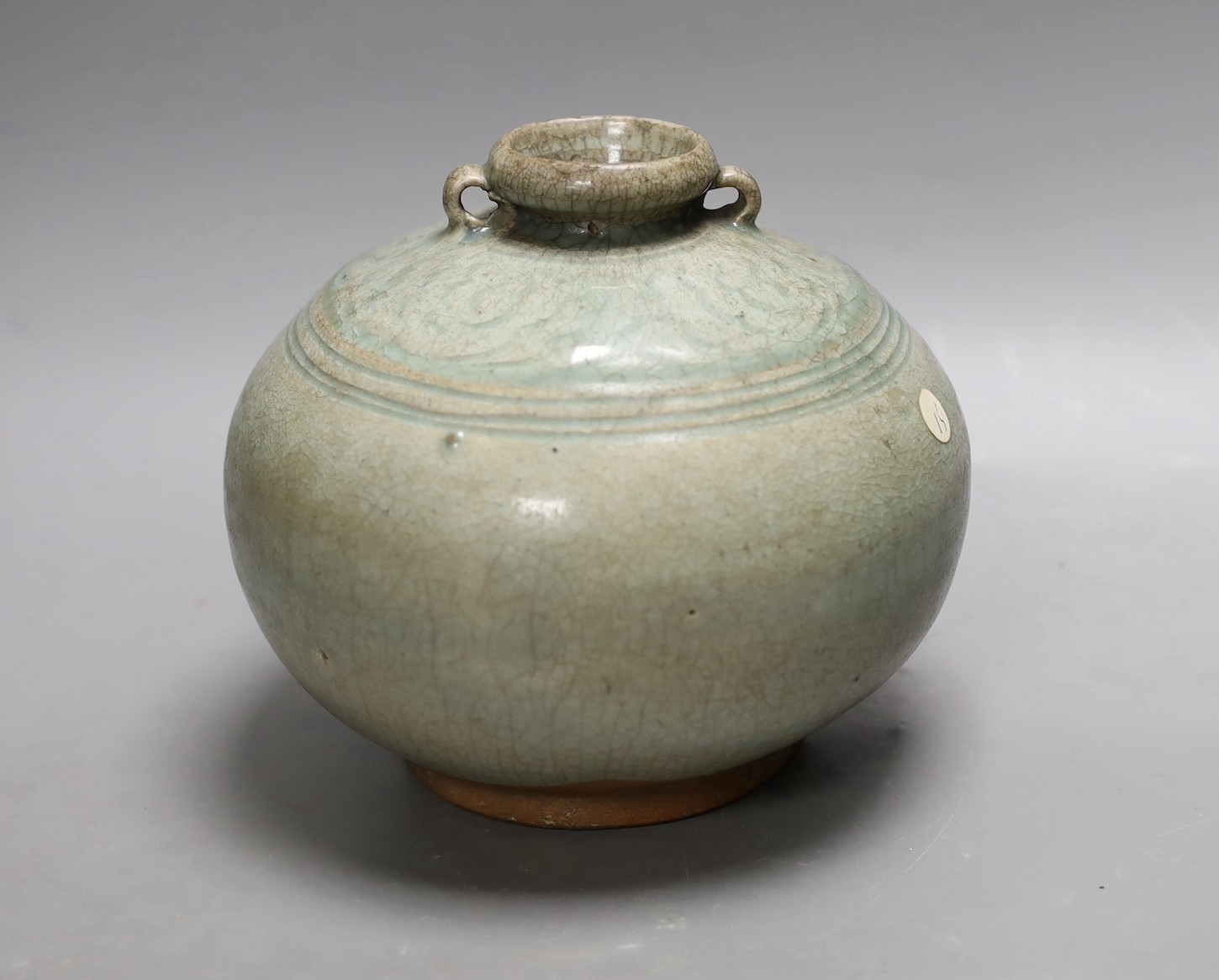 A Thai Sawankhalok green glazed ring handled jar, 15th century